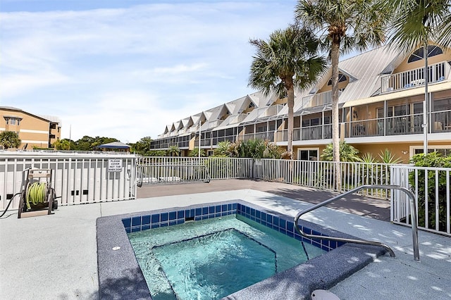 view of swimming pool featuring a hot tub