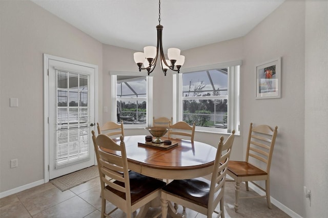 dining area with plenty of natural light, light tile patterned floors, and an inviting chandelier