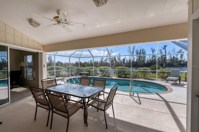 view of swimming pool featuring a lanai, ceiling fan, a water view, and a patio