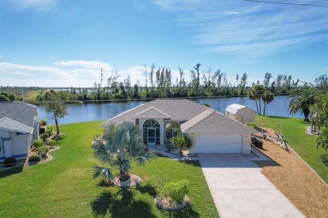 ranch-style house with a water view, a garage, and a front lawn