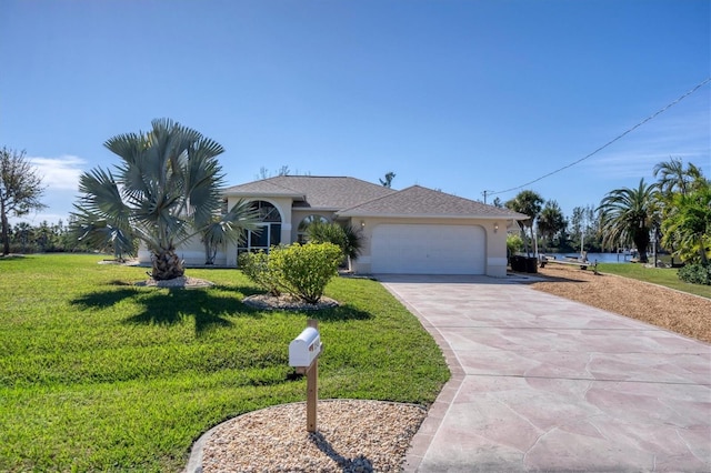 ranch-style home featuring a garage, a water view, and a front lawn