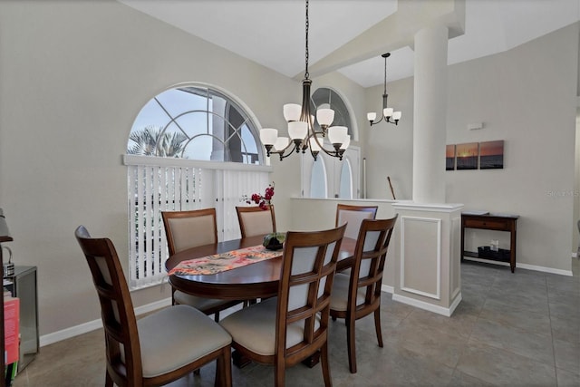 dining area featuring light tile patterned floors, high vaulted ceiling, and an inviting chandelier