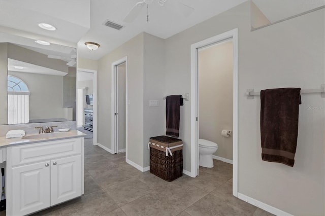 bathroom featuring tile patterned floors, vanity, ceiling fan, and toilet