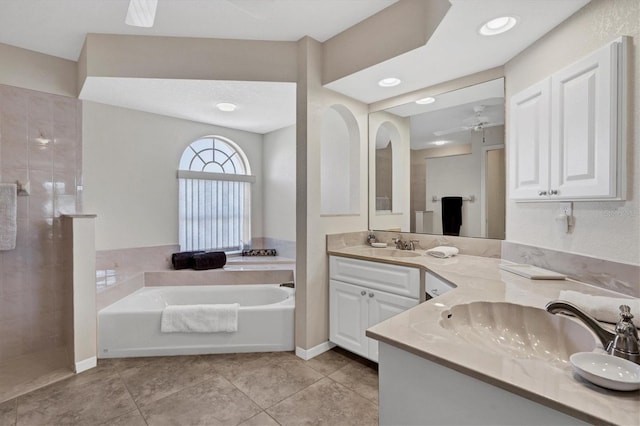 bathroom featuring a washtub, vanity, tile patterned floors, and ceiling fan