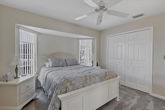 bedroom with ceiling fan, carpet floors, and a closet