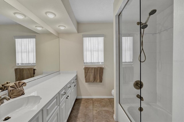 full bathroom featuring vanity, tile patterned floors, tiled shower / bath, and a healthy amount of sunlight