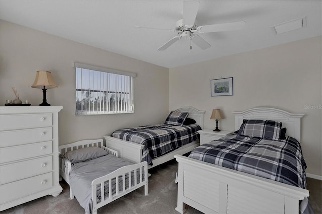 bedroom with ceiling fan and dark carpet