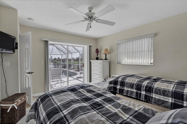 bedroom with ceiling fan, access to exterior, and a textured ceiling