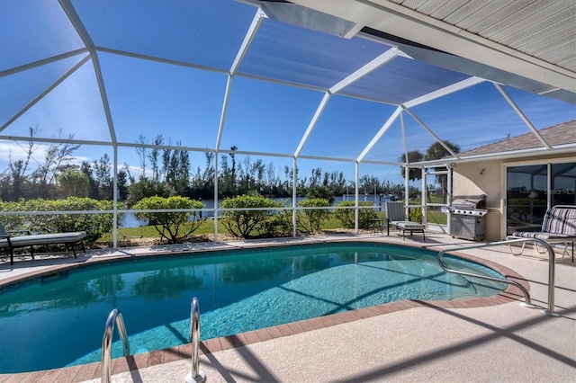 view of swimming pool with grilling area, a patio, and glass enclosure