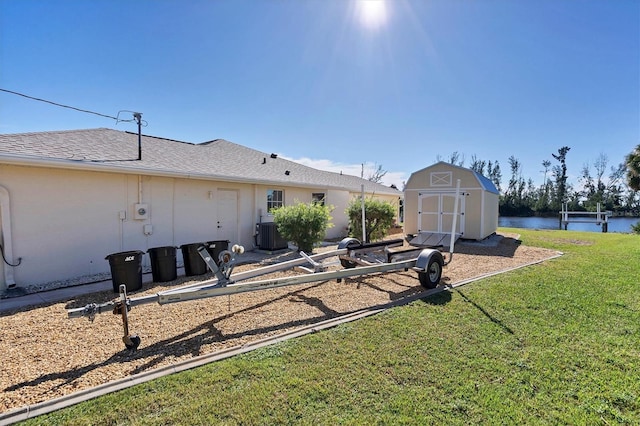 view of yard featuring a storage unit and a water view