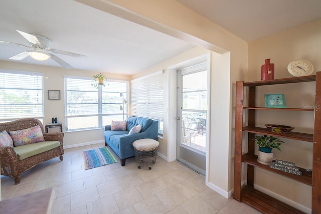 sitting room with ceiling fan and light tile patterned flooring