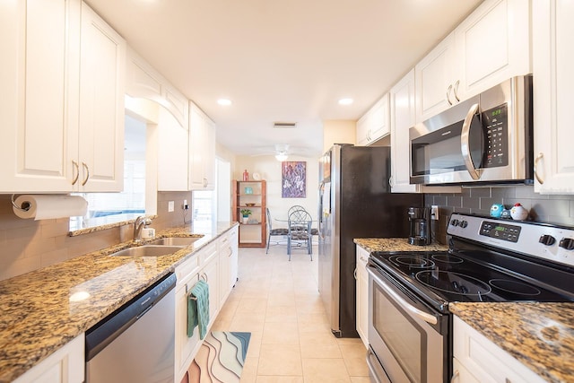 42 Caroll Cir, Englewood, FL 34223 - kitchen featuring stainless steel appliances, decorative backsplash, white cabinetry, and recessed lighting