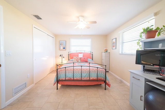 42 Caroll Cir, Englewood, FL 34223 - bedroom with multiple windows, a ceiling fan, and light tile patterned flooring