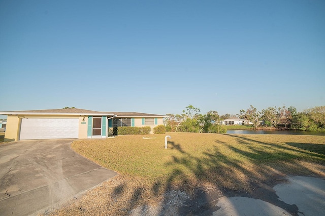 view of front facade with a front lawn, a water view, and a garage