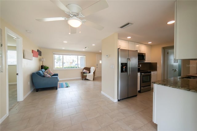 42 Caroll Cir, Englewood, FL 34223 - kitchen with appliances with stainless steel finishes, open floor plan, white cabinets, a ceiling fan, and recessed lighting