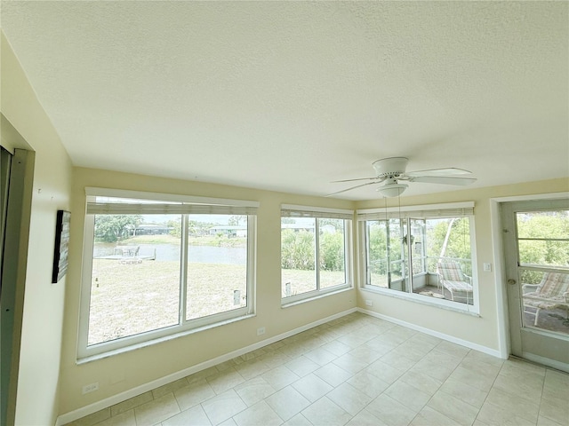 42 Caroll Cir, Englewood, FL 34223 - unfurnished sunroom featuring tile patterned floors and a textured ceiling