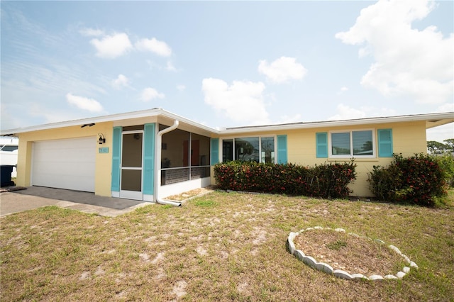 42 Caroll Cir, Englewood, FL 34223 - ranch-style house with an attached garage, a front yard, driveway, and a sunroom
