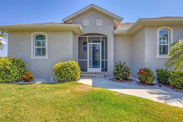 entrance to property with a yard