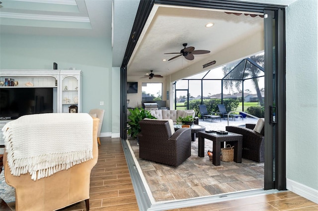 living room with wood-type flooring, ceiling fan, and crown molding