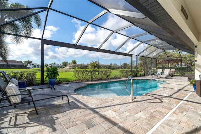 view of swimming pool with glass enclosure and a patio area