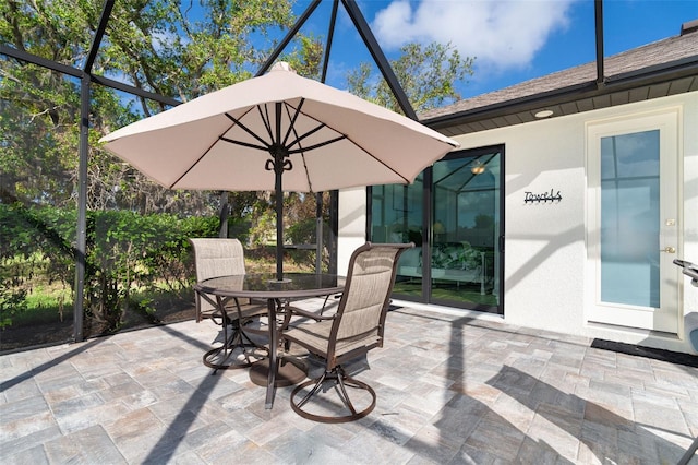 view of patio with glass enclosure