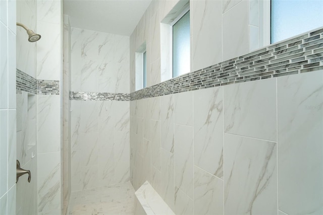 bathroom with a tile shower