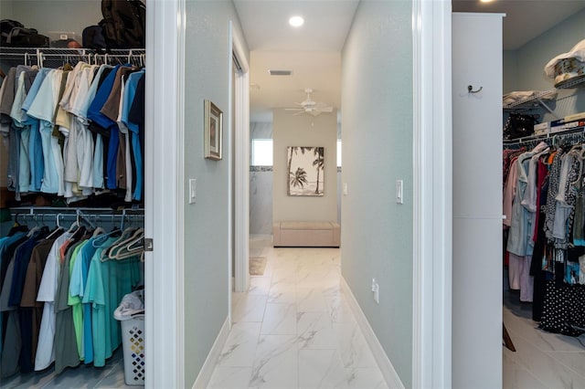 walk in closet featuring ceiling fan