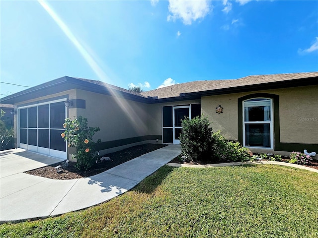 view of front of home featuring a garage and a front lawn