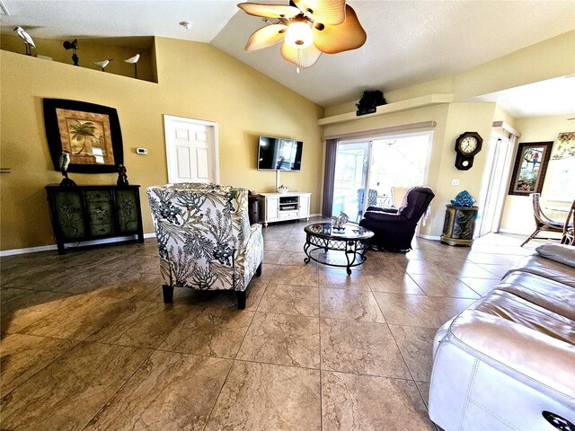 living room with ceiling fan and lofted ceiling