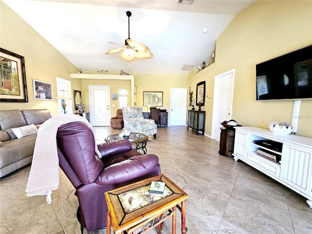 living room with ceiling fan and vaulted ceiling