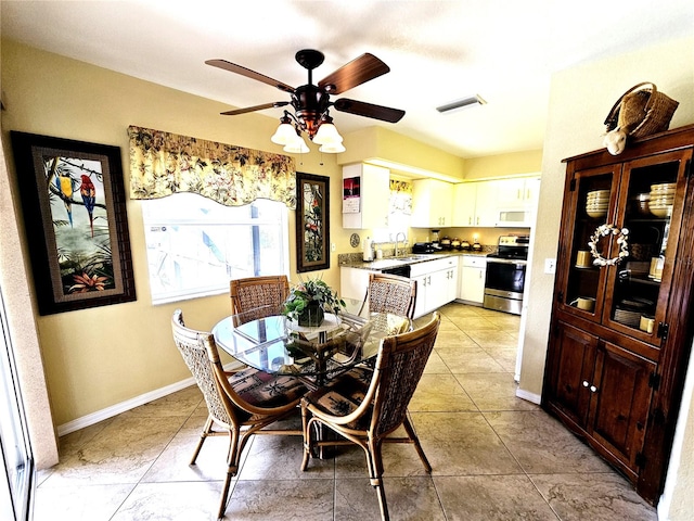 dining room featuring ceiling fan and sink