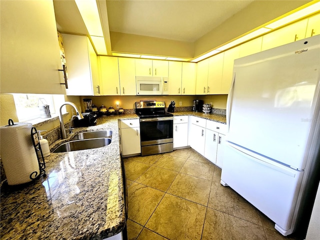 kitchen with white cabinets, white appliances, dark stone countertops, and sink