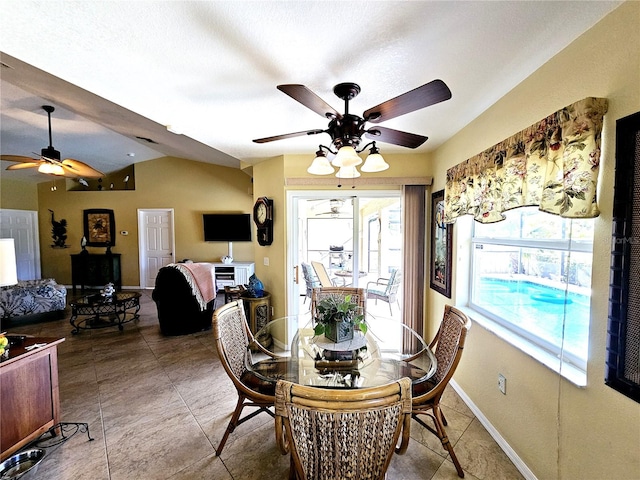 dining room featuring a textured ceiling, vaulted ceiling, and ceiling fan