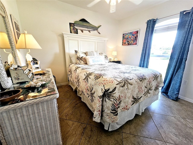 tiled bedroom featuring ceiling fan