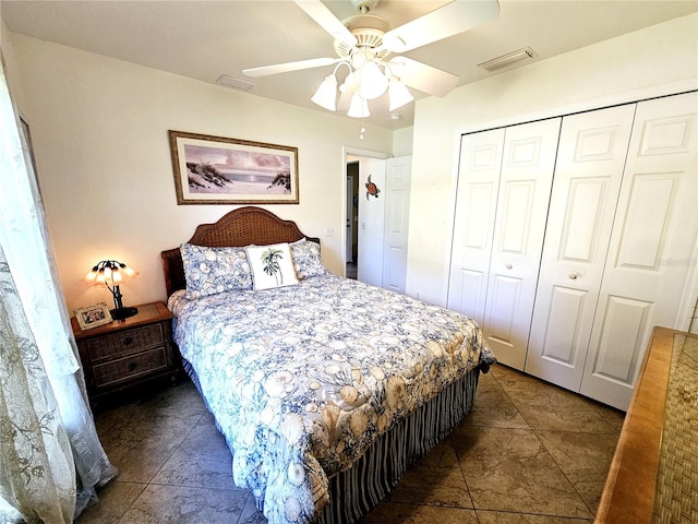 tiled bedroom with ceiling fan and a closet