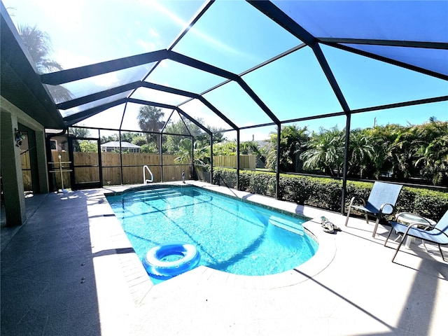 view of pool featuring a patio and glass enclosure