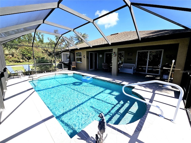 view of swimming pool featuring a lanai and a patio area