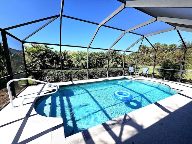 view of swimming pool with a lanai