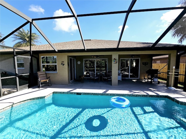 view of pool with a patio area, ceiling fan, and a lanai