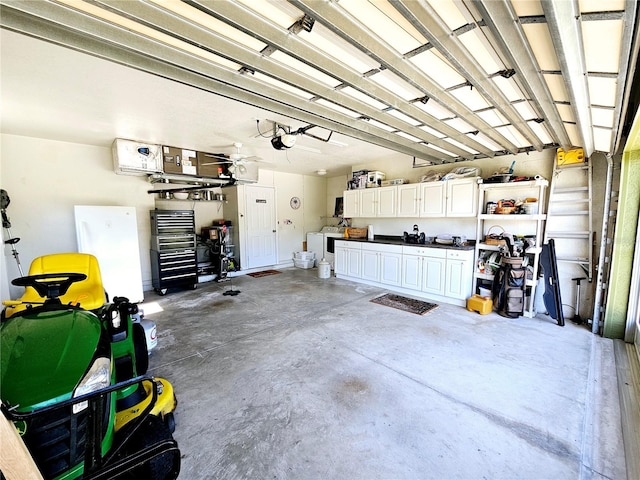 garage featuring a workshop area, a garage door opener, and ceiling fan