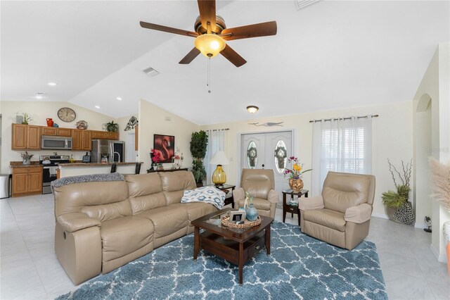 13515 Keystone Blvd, Port Charlotte, FL 33981 - living room with vaulted ceiling, light tile patterned flooring, a ceiling fan, and arched walkways