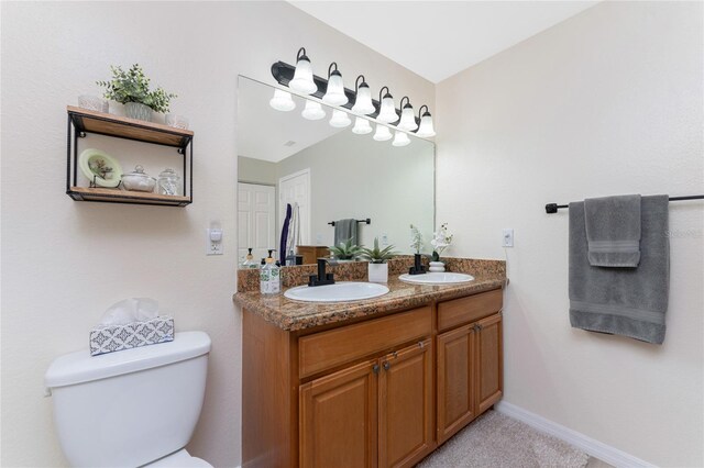 13515 Keystone Blvd, Port Charlotte, FL 33981 - bathroom with toilet, double vanity, and baseboards