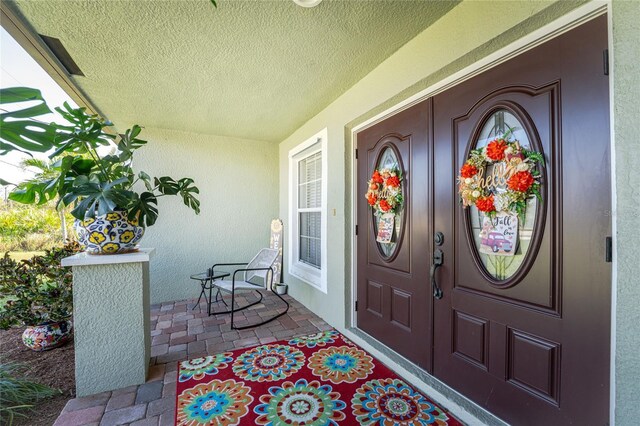 13515 Keystone Blvd, Port Charlotte, FL 33981 - property entrance with a porch and stucco siding