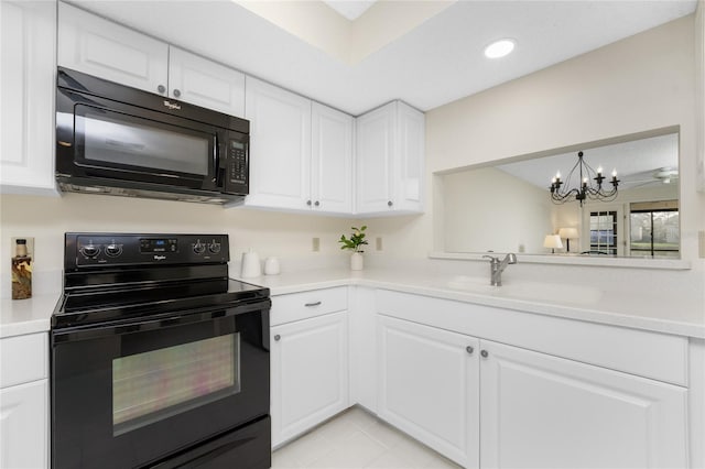 kitchen featuring sink, black appliances, light tile patterned floors, white cabinets, and a chandelier