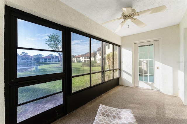 sunroom / solarium with ceiling fan and a healthy amount of sunlight