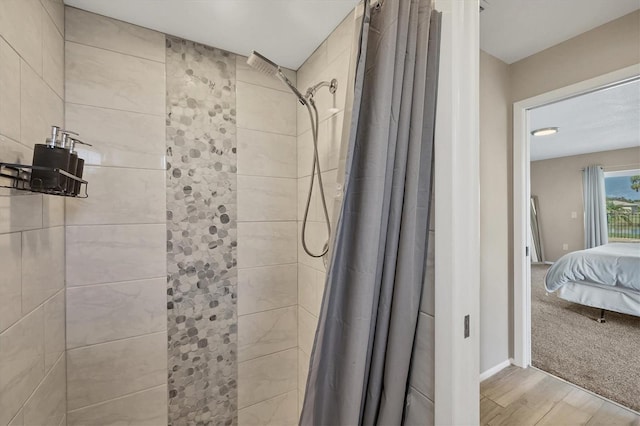 bathroom featuring a shower with shower curtain and wood-type flooring