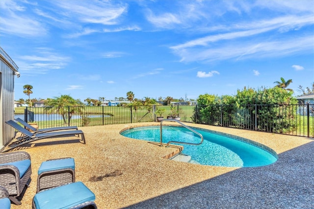 view of pool with a water view and a patio