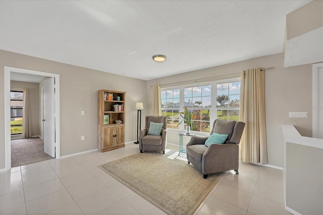 living area with light tile patterned flooring and a textured ceiling