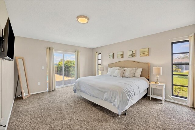 carpeted bedroom featuring access to exterior