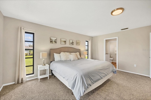 carpeted bedroom featuring connected bathroom